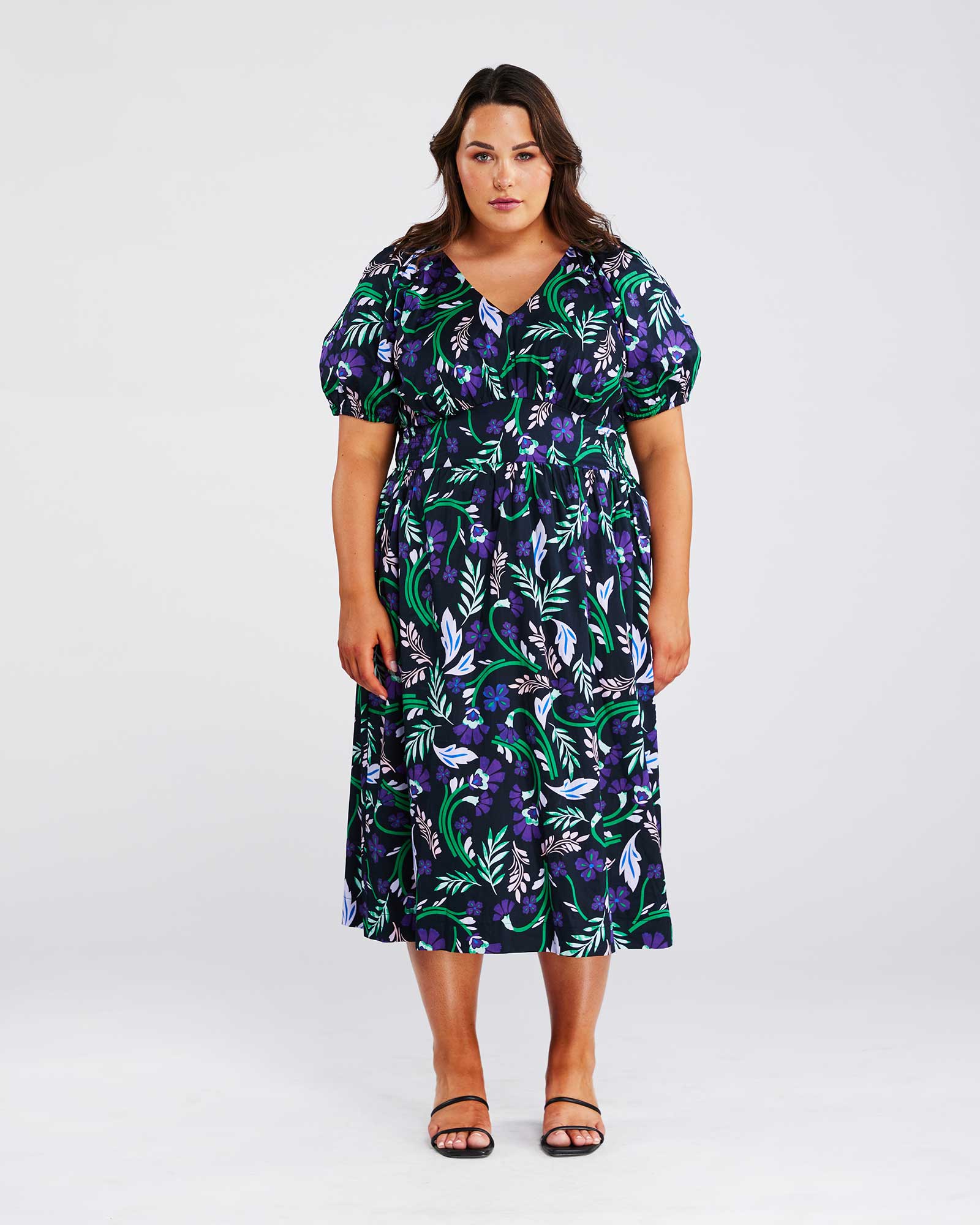 A plus-size woman making a fashion statement in the Ultraviolet Cotton Floral Midi Dress.