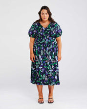 A plus-size woman making a fashion statement in the Ultraviolet Cotton Floral Midi Dress.