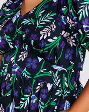 A plus-size fashionista wearing the Ultraviolet Cotton Floral Midi Dress.