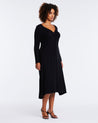 A versatile plus-sized woman wearing the Florentine Black Long Sleeve Midi Knit Dress.