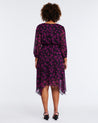 The back view of a woman wearing a Boysenberry Bloom Black Pink Floral Midi Dress exuding comfort and elegance.