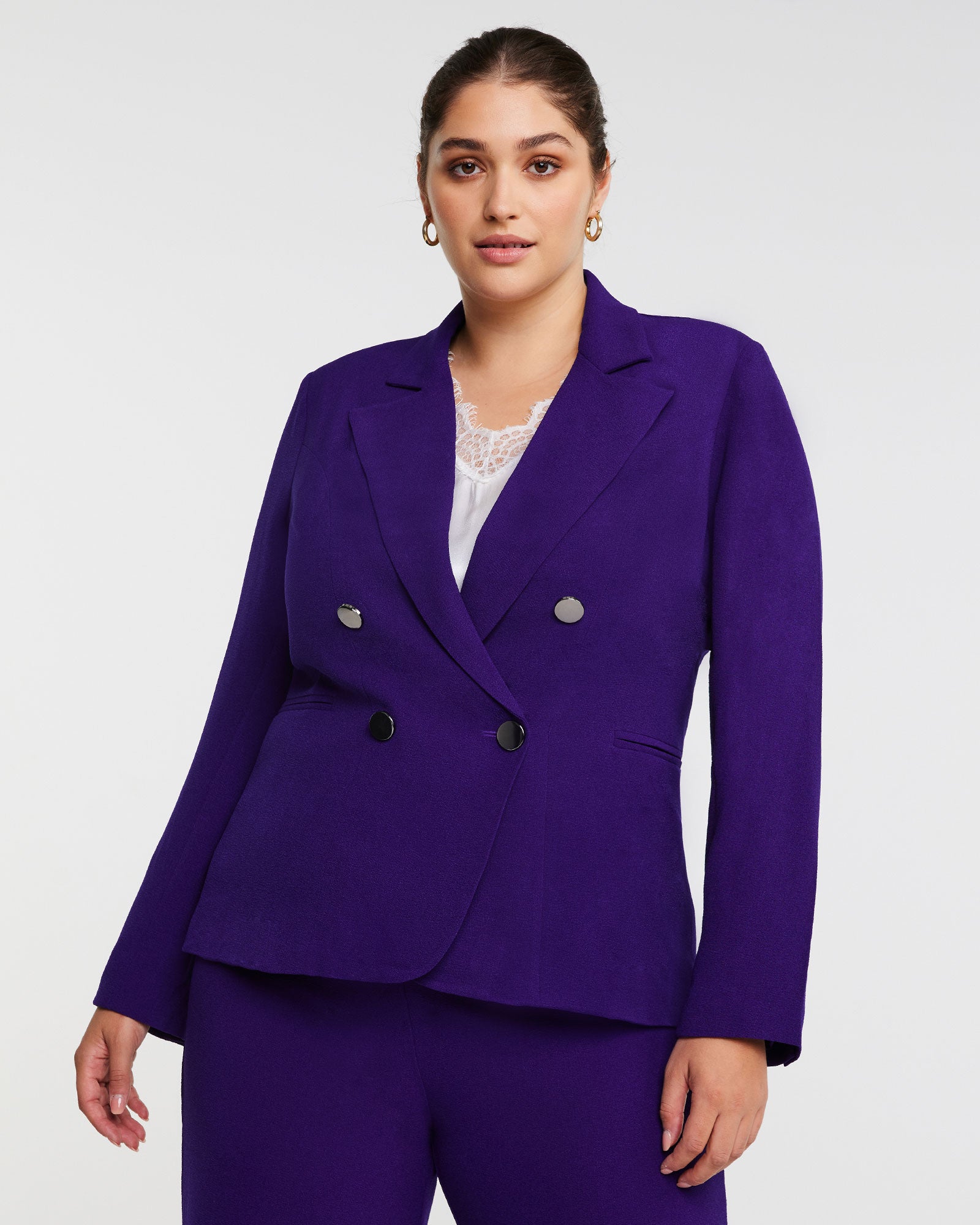 A Clever Blazer Jacket in Purple woman wearing a double-breasted purple blazer.