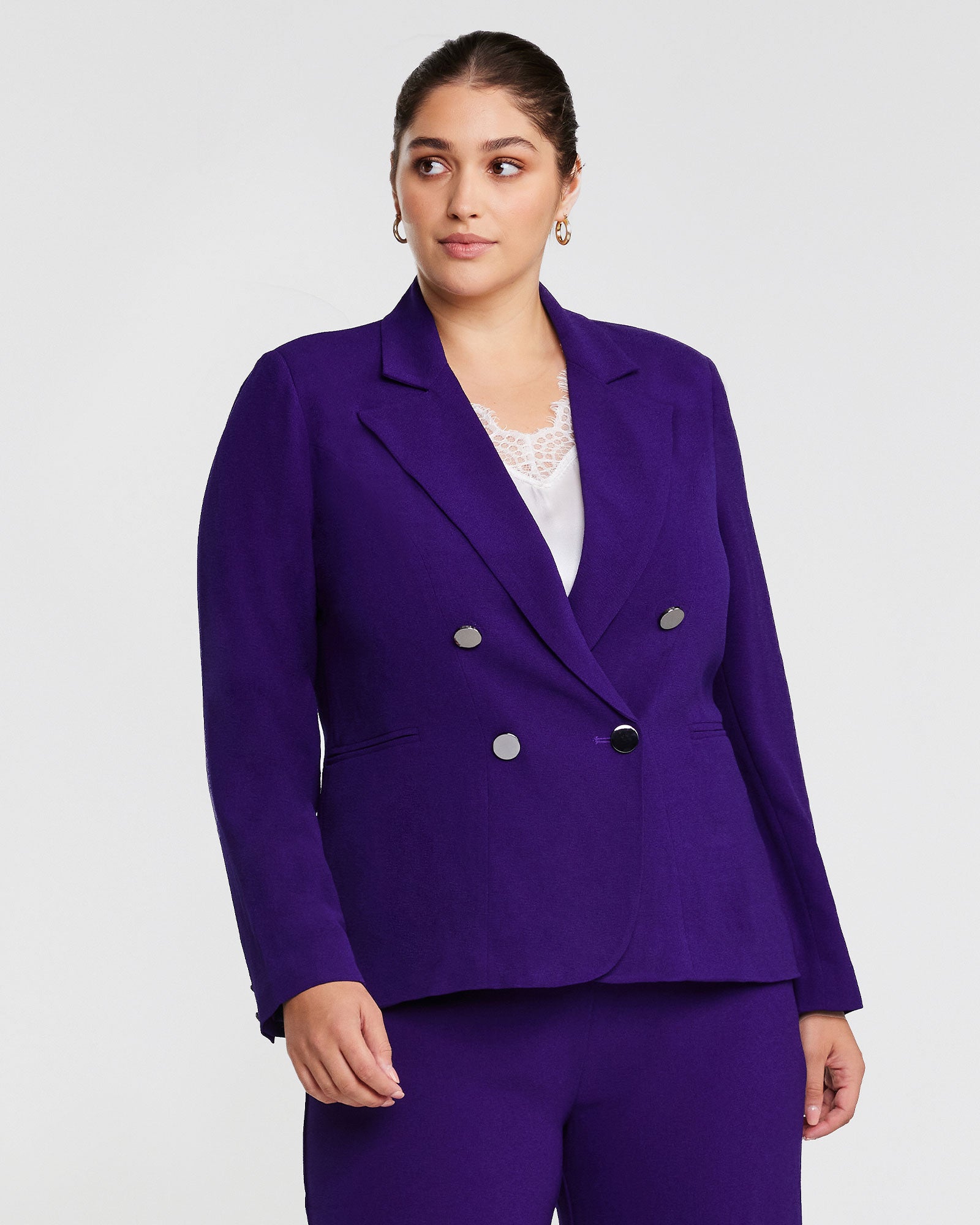 A woman wearing a Clever Blazer Jacket in Purple.