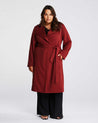 A plus size woman wearing a Estelle Georgie Trench Coat- Ginger.