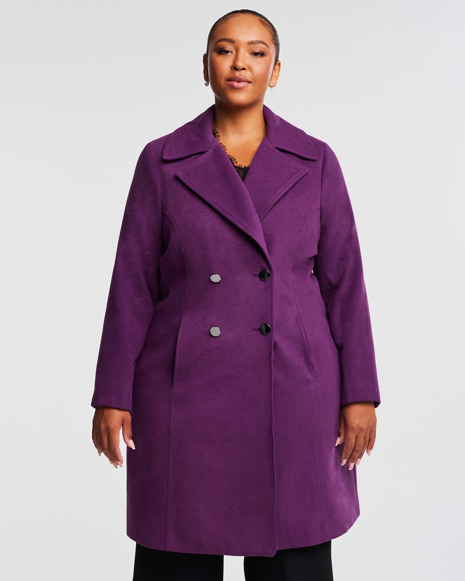 A woman wearing the Estelle Violet Sky Double Breasted Coat and black pants.
