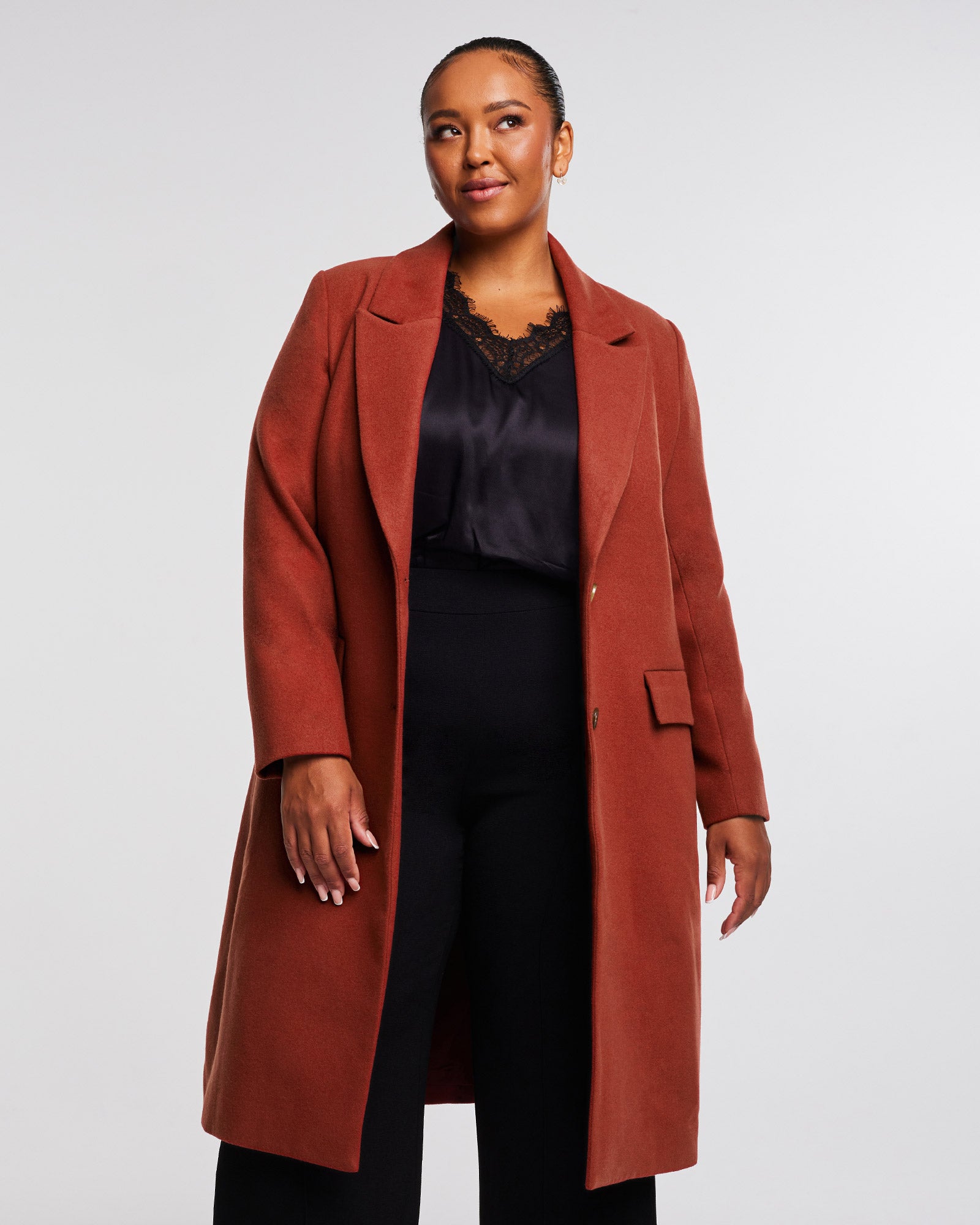 A plus-sized woman wearing a red Mia Rust Full-Length coat.