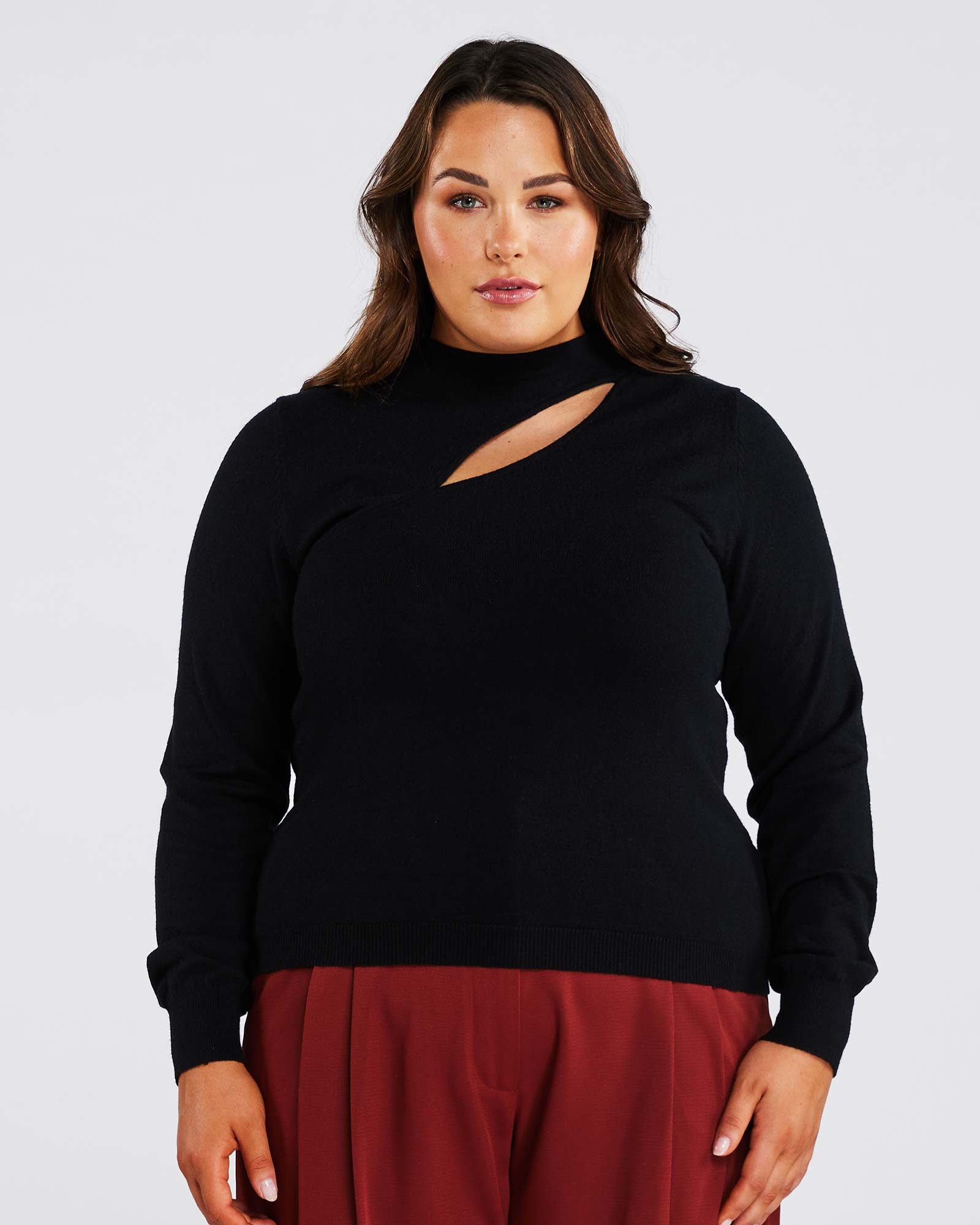 A plus-size woman rocking a Black Cut Out Crewneck Sweater, showcasing her fashion quotient.