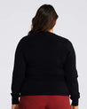 The back view of a plus-size woman wearing a Black Cut Out Crewneck Sweater.