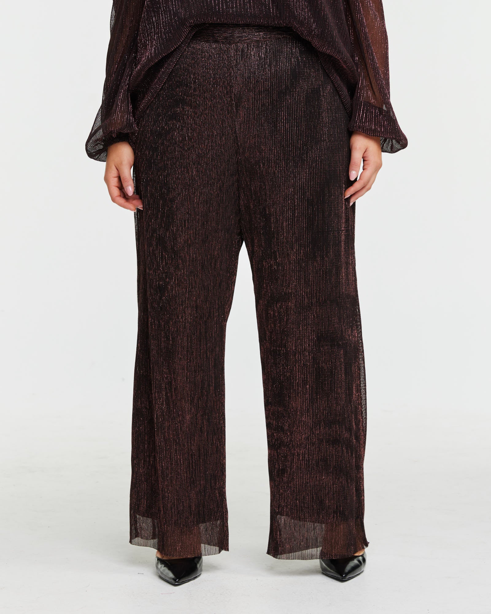 A model is wearing the Camille Lurex Pant with an elasticated waistband.