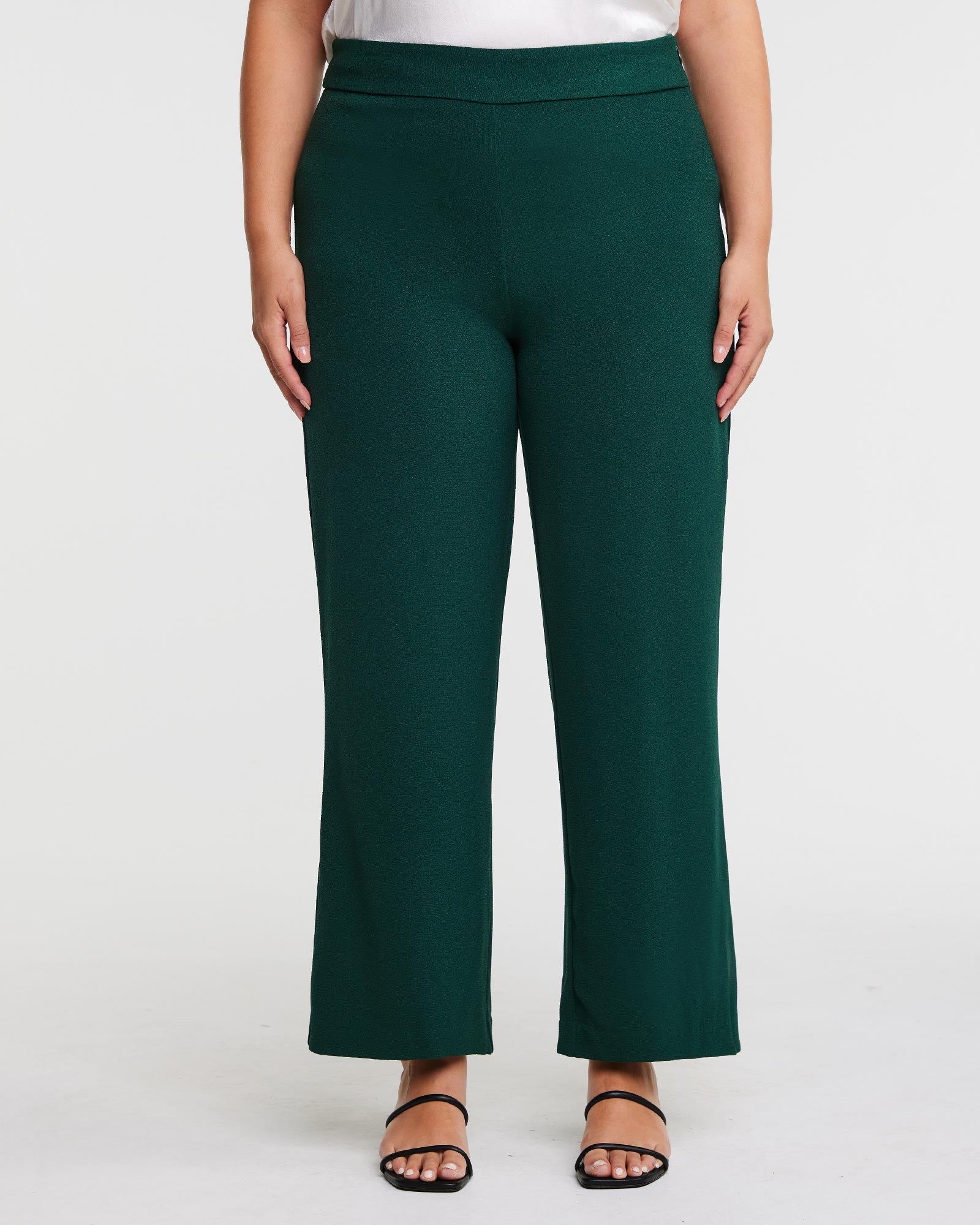 A plus size woman wearing the Estelle Nightlife Green Wide Leg Pant.