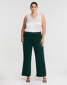 A model wearing the Estelle Nightlife Green Wide Leg Pant and a white top.