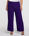 A woman wearing the Nightlife Purple Wide Leg Pant in textured polyester fabric.