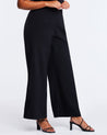 A plus-sized model wearing Savannah Black Wide-Leg Pant, elevating a capsule wardrobe.