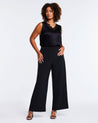 A plus-sized woman elevating her capsule wardrobe with Savannah Black Wide-Leg Pant and a black top.