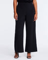 A plus-sized woman wearing the Savannah Black Wide-Leg Pant to elevate her capsule wardrobe.