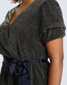 A plus size woman wearing the Estelle Vega Tie Top dress.