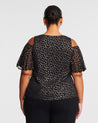 The back view of a woman in an Estelle Gold Dust Cold Shoulder Top.