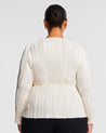 The back view of a plus-size woman wearing the Alexandra Cream Wrap-Illusion Pleated Top.