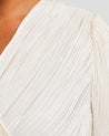 A versatile plus-size woman in an Alexandra Cream Wrap-Illusion Pleated Top.